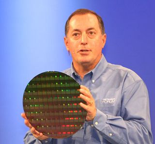 Otellini holds up prototype wafers of an upcoming 80 core teraflop processor.