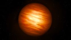 a reddish orb streaked with pale yellows on a black background