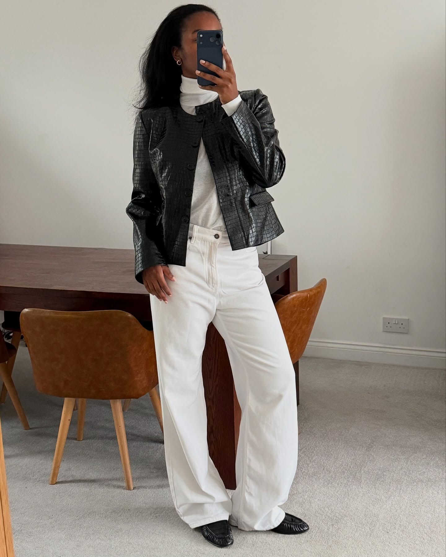 Woman wearing croc jacket, a very big spring 2026 jacket trend.