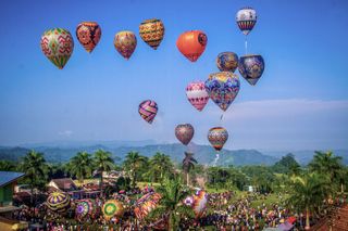 The sky over Wonosobo, Central Java, is filled with colourful hot air balloons as Indonesians celebrate Eid al-Fitr at the Ansor Kertek Balloon Culture Festival