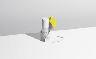 NUORI skincare product in a white bottle, and white and yellow packaging photographed on a white background.