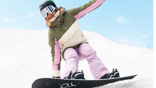 Woman snowboarding wearing Roxy Shelter Jacker