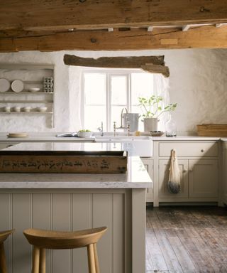 greige kitchen cabinets with wooden beams