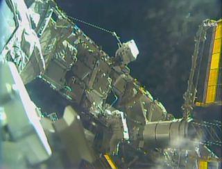 This view shows astronauts Shane Kimbrough (in red-striped spacesuit) and Peggy Whitson (all-white) work on the main truss of the International Space Station during a spacewalk on Jan. 6, 2017.