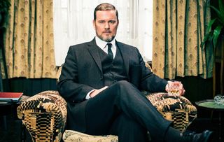 Craig McLachlan seated