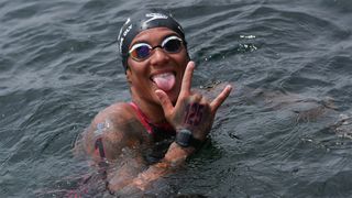 Brazil&#039;s Ana Marcela Cunha raises a hand and sticks her tongue out at the camera at the World Aquatics Open Water Swimming World Cup in 2024.