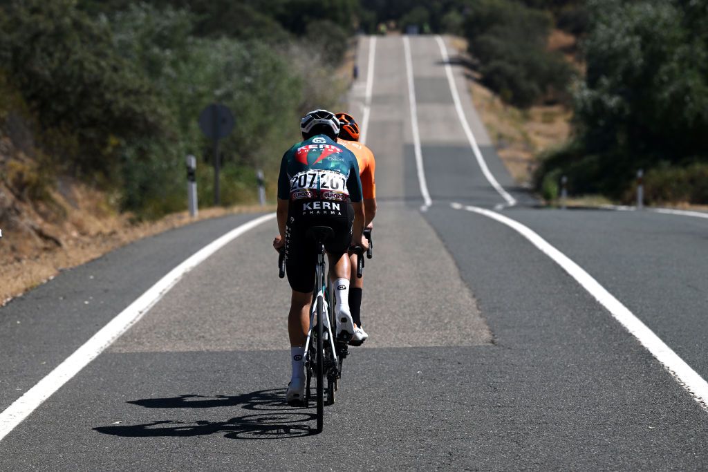 SEVILLE SPAIN AUGUST 21 LR Ibon Ruiz of Spain and Team Equipo Kern Pharma and Txomin Juaristi of Spain and Team Euskaltel Euskadi compete in the breakaway during La Vuelta 79th Tour of Spain 2024 Stage 5 a 177km stage Fuente del Maestre to Seville UCIWT on August 21 2024 in Seville Spain Photo by Dario BelingheriGetty Images