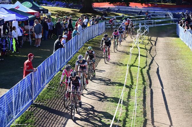 Emma White (Cyclocrossworld.com) leading a long train of women chasing Helen Wyman