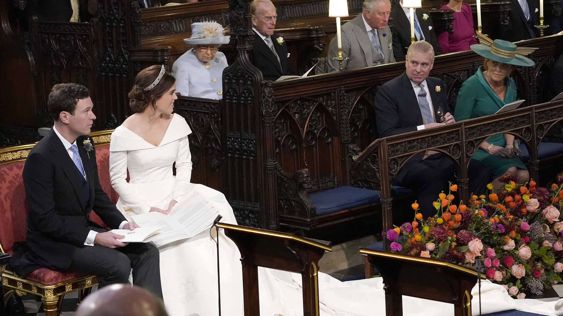 WINDSOR, ENGLAND - OCTOBER 12: Princess Eugenie and her husband Jack Brooksbank, look back towards the Duke of York and Sarah, Duchess of York (seated front) and Queen Elizabeth II, the Duke of Edinburgh, Prince of Wales, the Duke and Duchess of Cambridge, and the Duke and Duchess of Sussex, during their wedding at St George&#039;s Chapel in Windsor Castle on October 12, 2018 in Windsor, England. (Photo by Danny Lawson - WPA Pool/Getty Images)