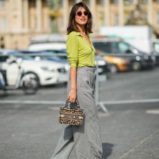 Jeanne Damas spotted at Paris Fashion Week wearing a green cardigan and trousers