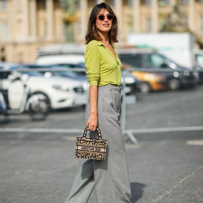 Jeanne Damas spotted at Paris Fashion Week wearing a green cardigan and trousers