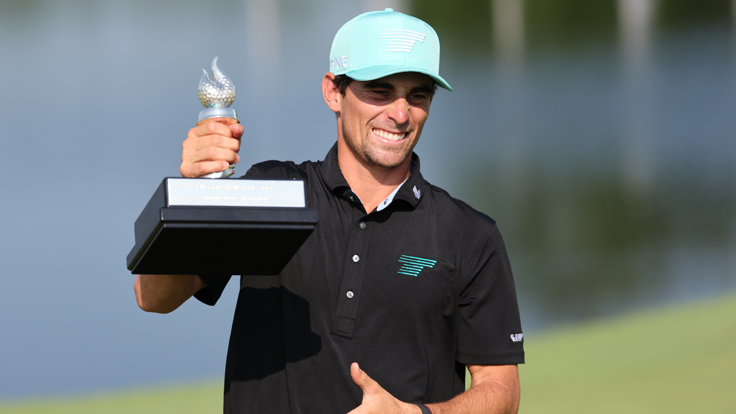 Joaquin Niemann with the LIV Golf New York trophy