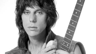 Jeff Beck holding a guitar (studio portrait)