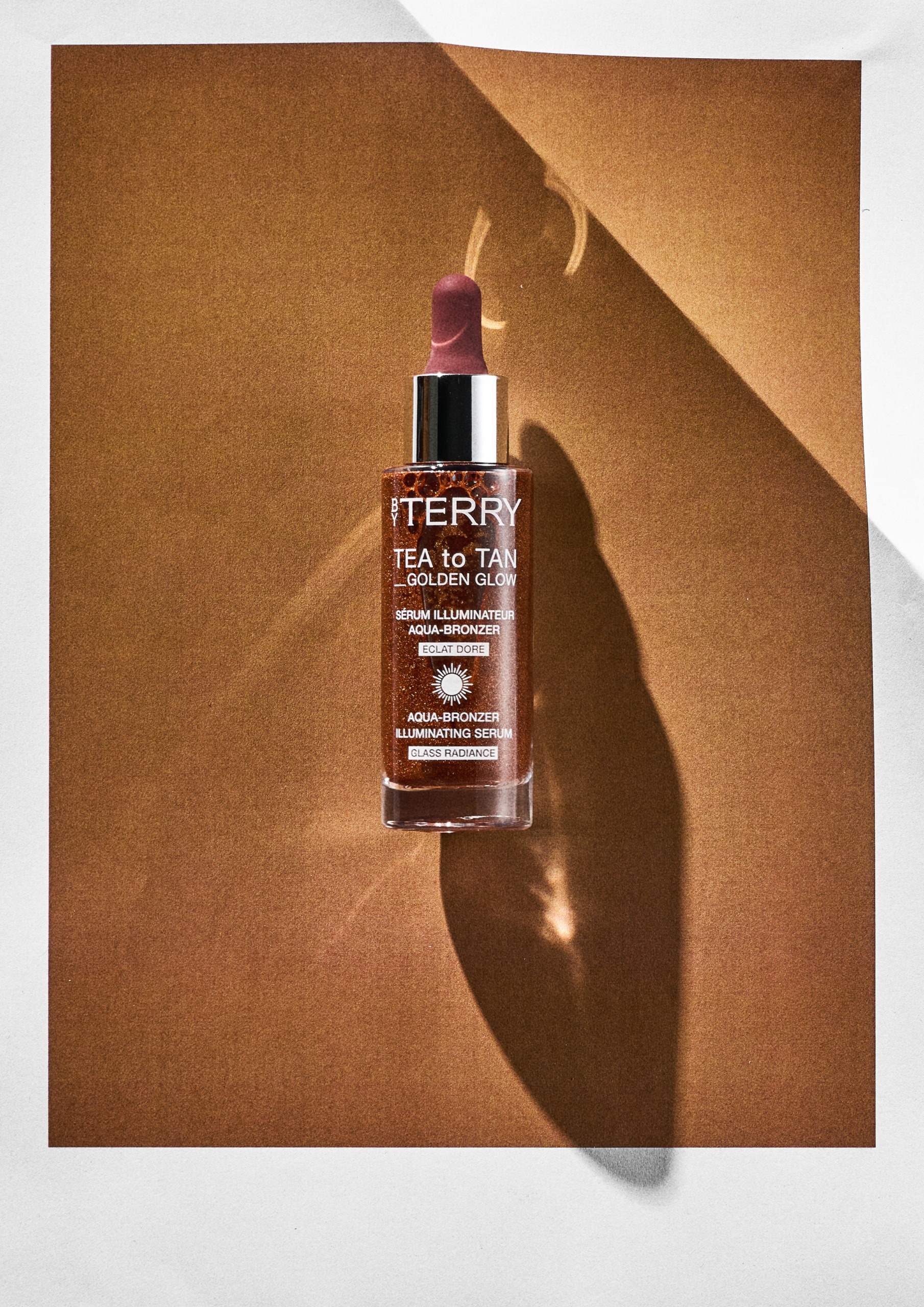 By Terry Tea To Tan Golden Glow on an orange background