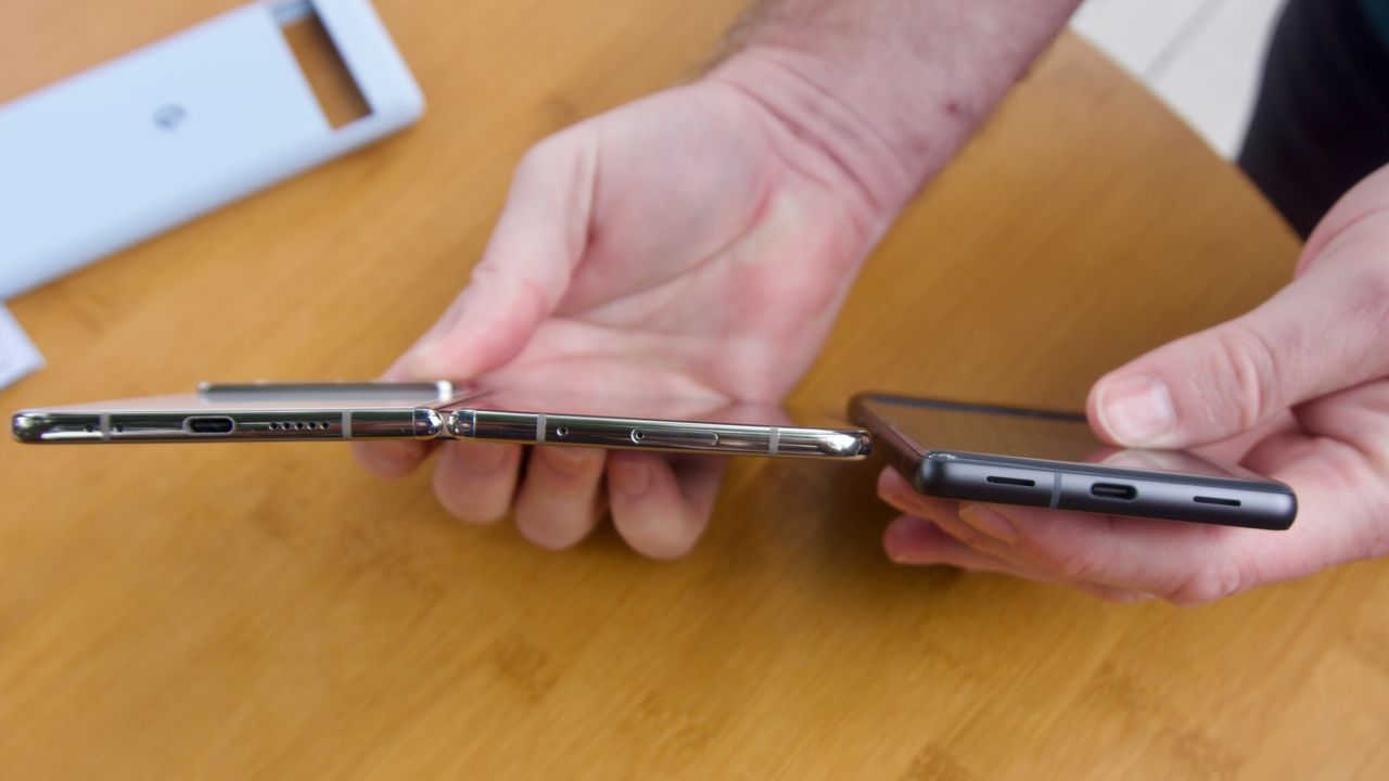 The Google Pixel Fold and Pixel 7a side-by-side, showing how much skinnier the Fold is.