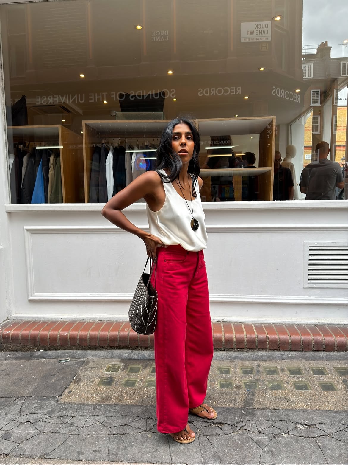 @monikh wears red jeans and a white vest