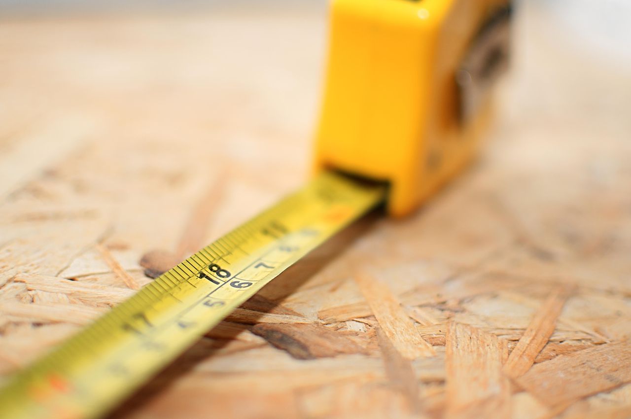 A DIY tape measure measuring particle board