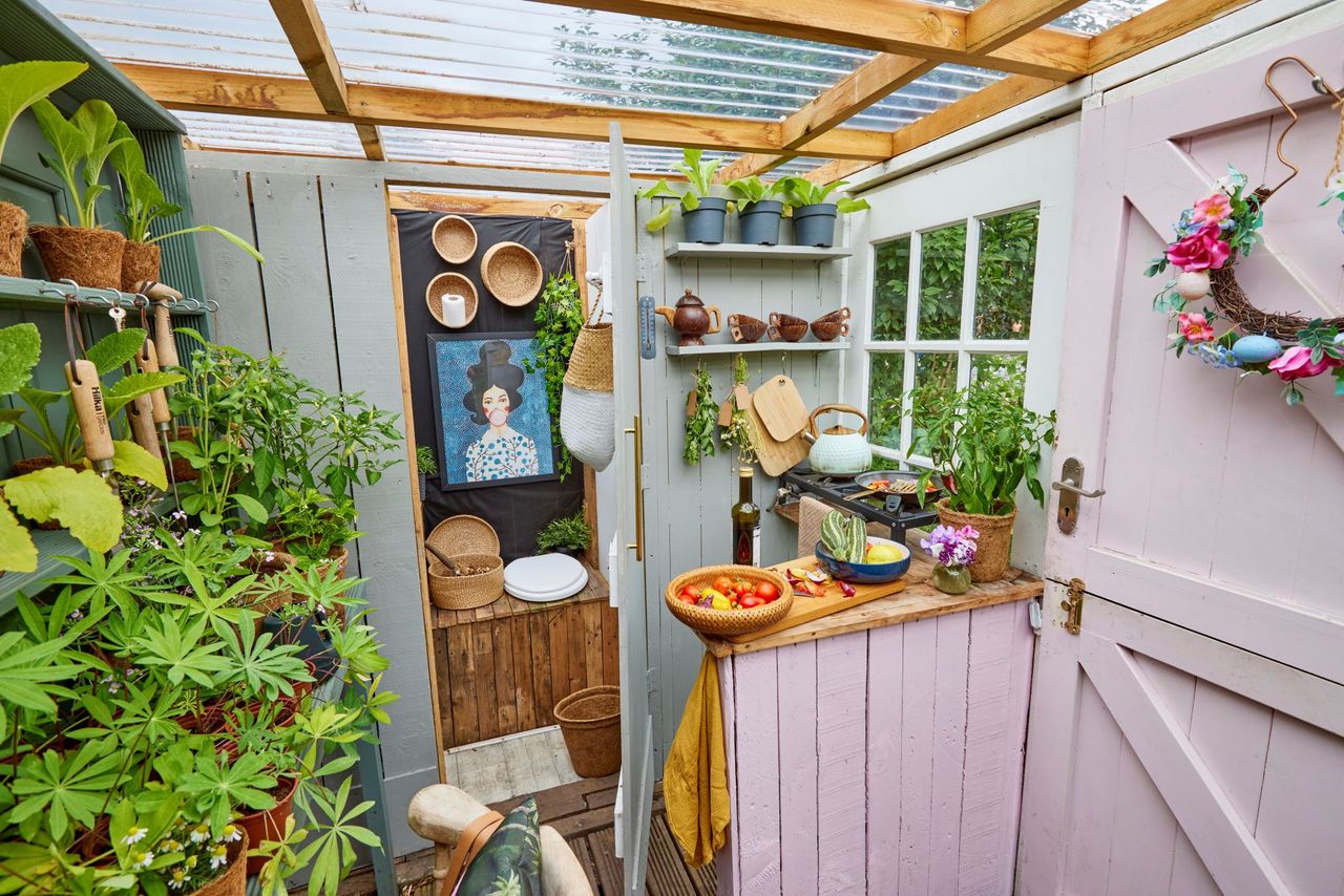 Potting shed with in built toilet inside the Shed of the Year with pink walls and plants lining the walls