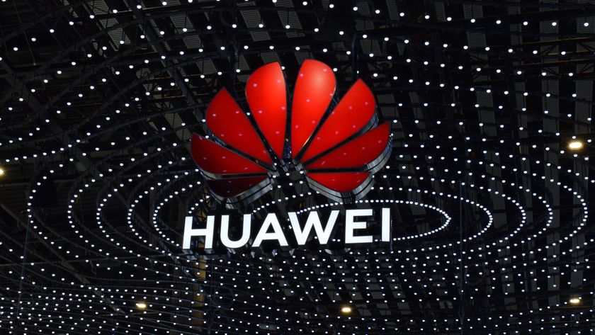 The Huawei logo suspended above the conference floor at MWC 2025, set against a backdrop of many small lights in concentric shapes.