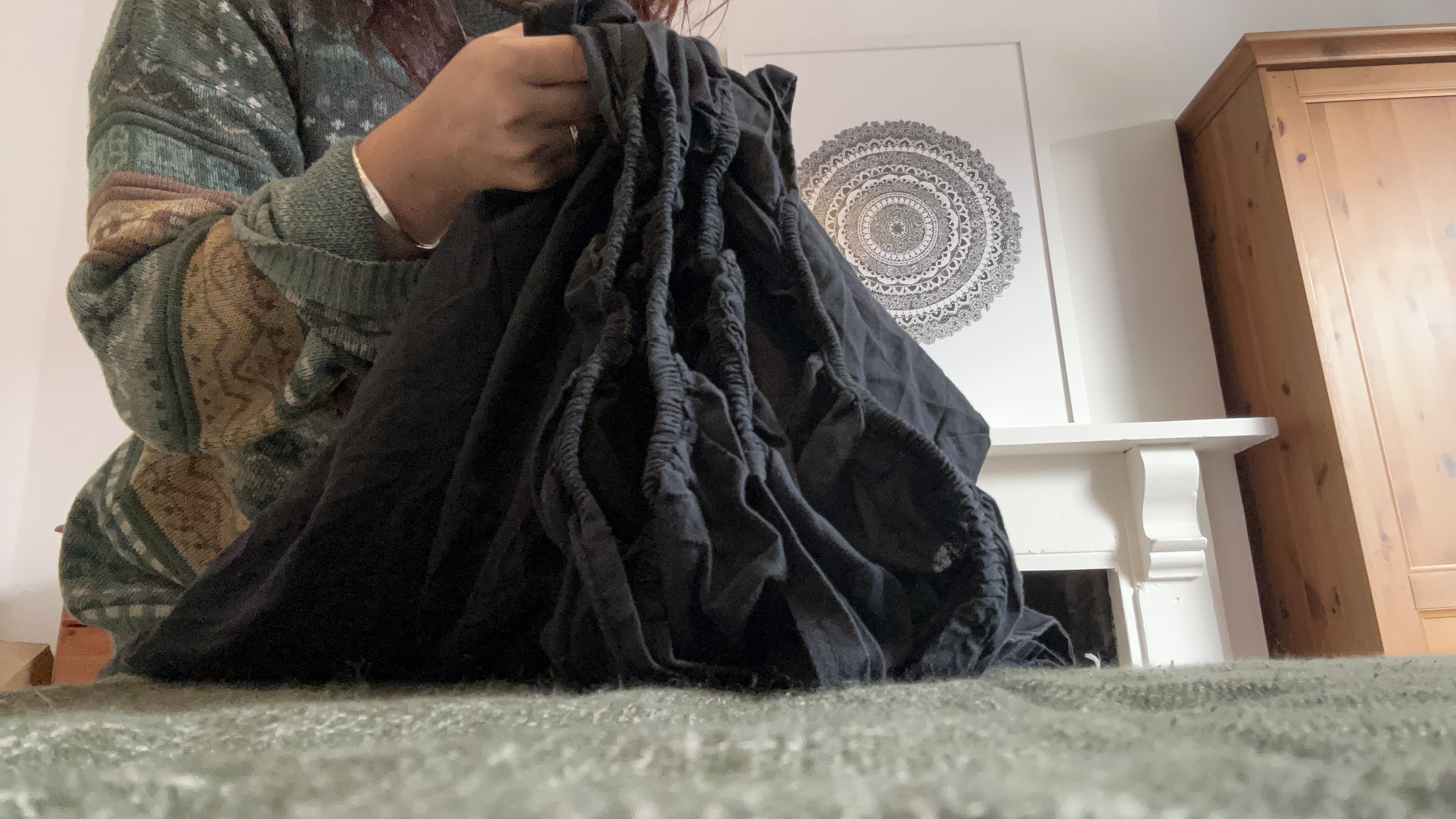 Tom's Guide Sleep Features Editor folding all the corners of a fitted sheet together
