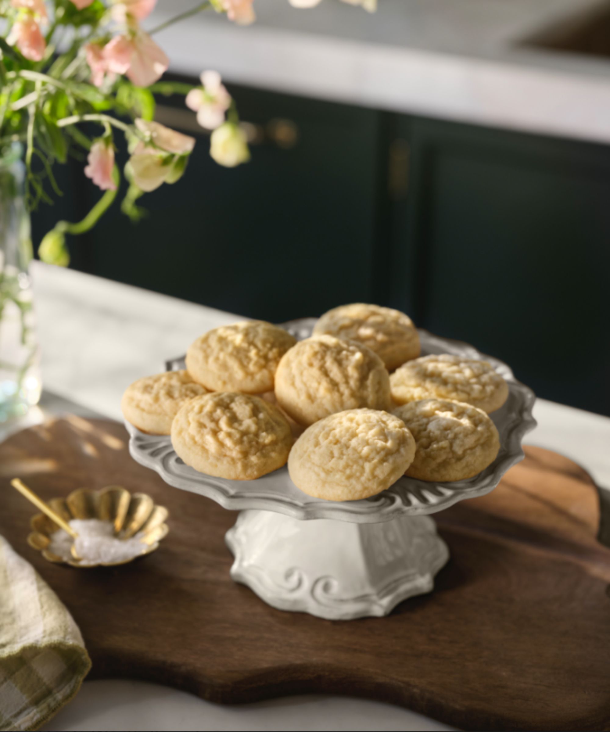 Joanna Gaines&#039; sugar cookies on a vintage style cake stand in a kitchen