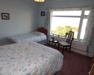 bedroom with window and floral curtains