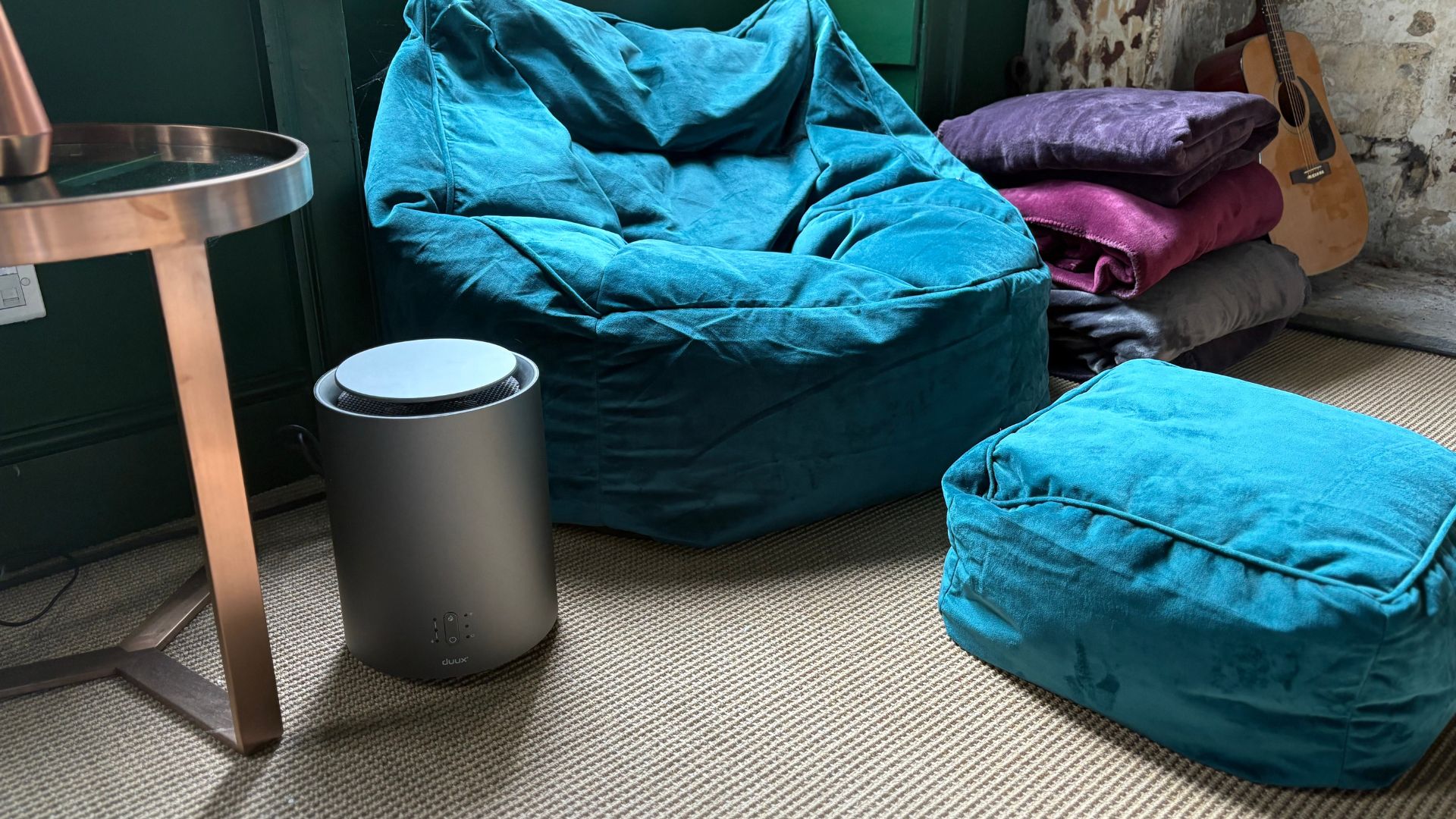 Duux ThreeSixty Smart Ceramic Fan Heater by a beanbag