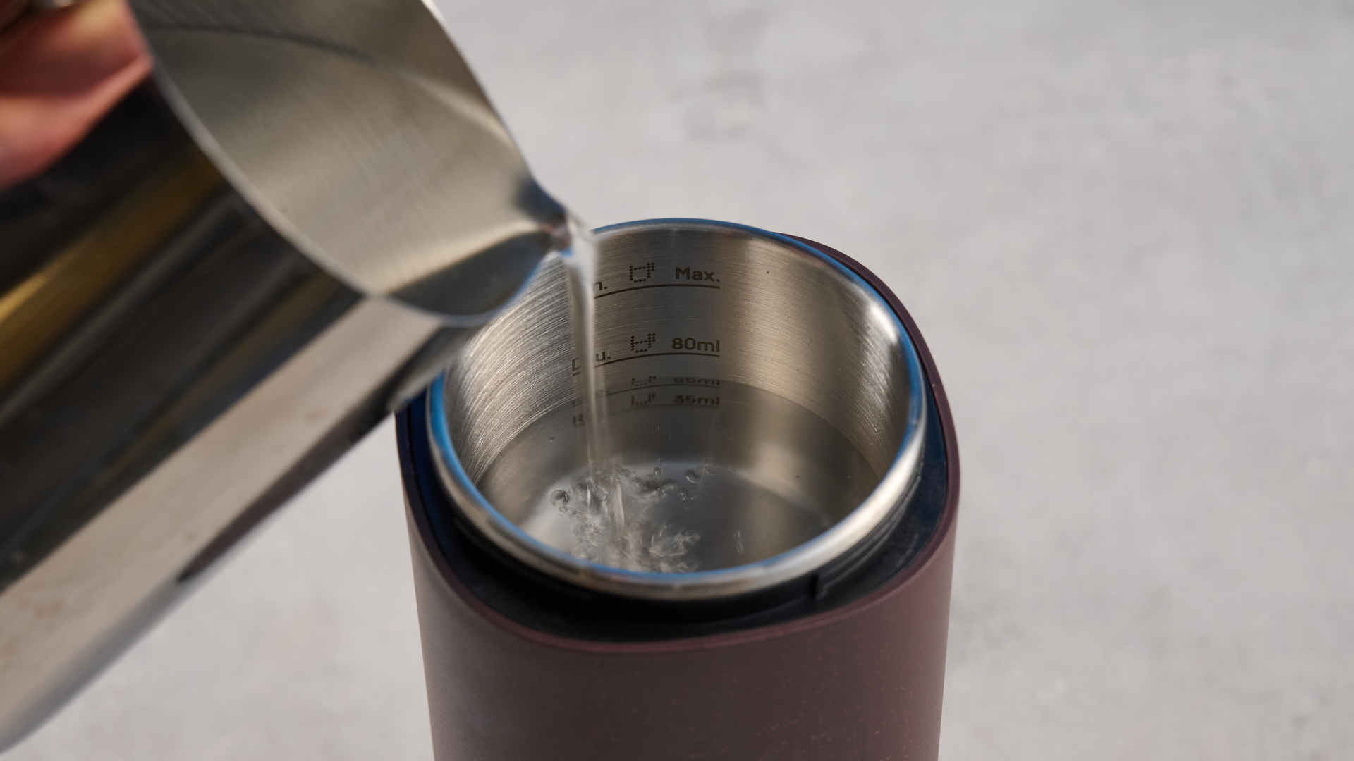 the wacaco pixapresso portable self-heating espresso maker in dark purple color showing usability with nespresso pods and ground coffee, ideal for vacations and camping
