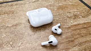 Apple AirPods Pro (2nd Generation) on table with pods out of the case