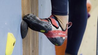 Woman's foot on indoor climbing wall