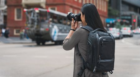 The Think Tank Walker Pro camera backpack worn by a photographer