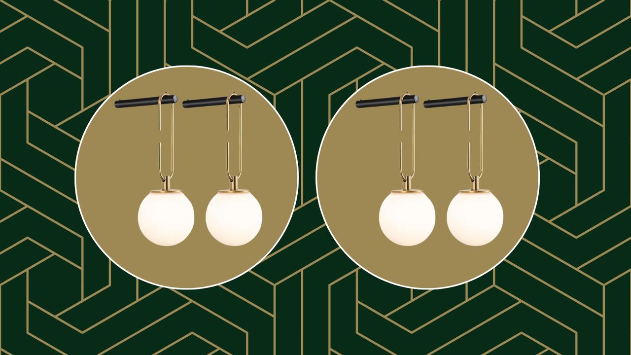 The Amazon wall sconces hanging from a black hook on a green and gold geometric background