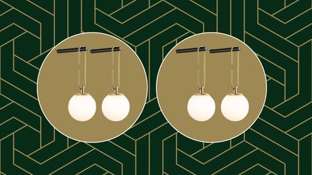 The Amazon wall sconces hanging from a black hook on a green and gold geometric background