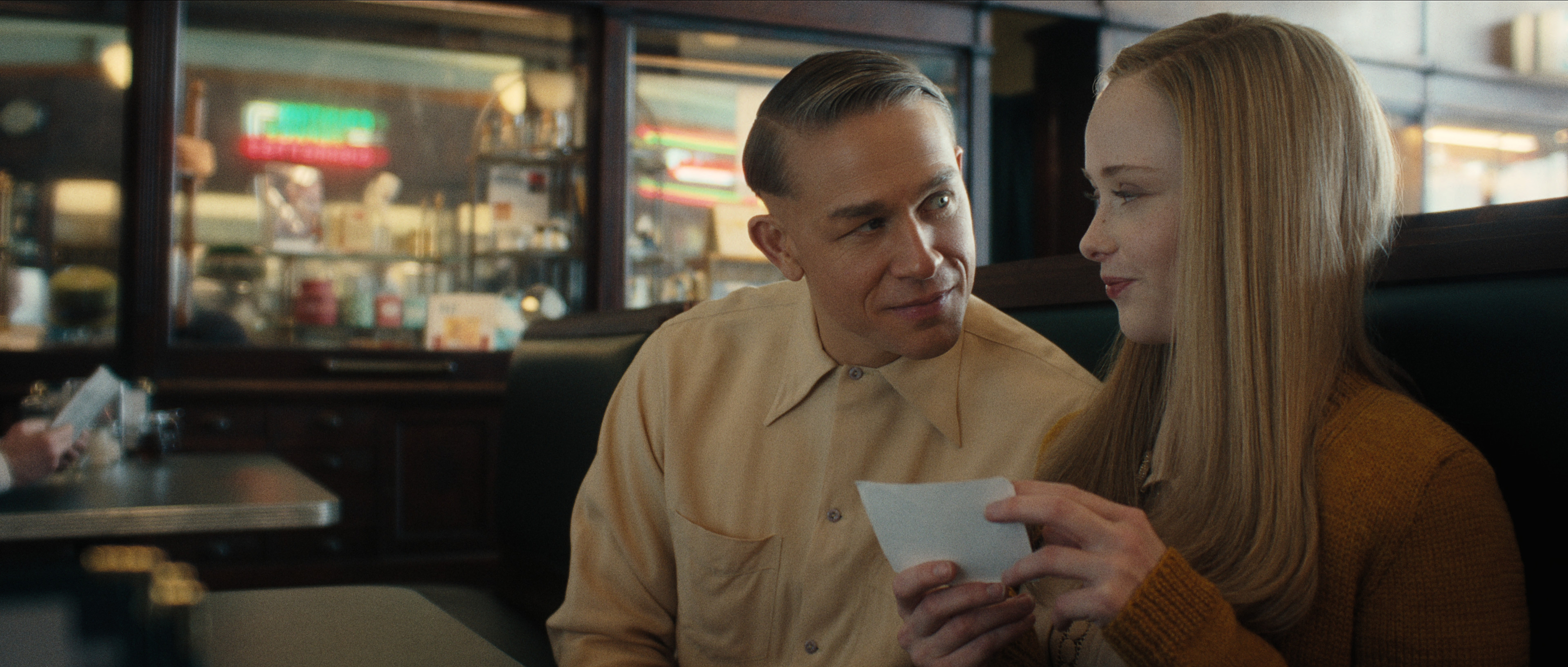 charlie hunnam as ed gein and suzanna son as adeline watkins in a diner booth in monster
