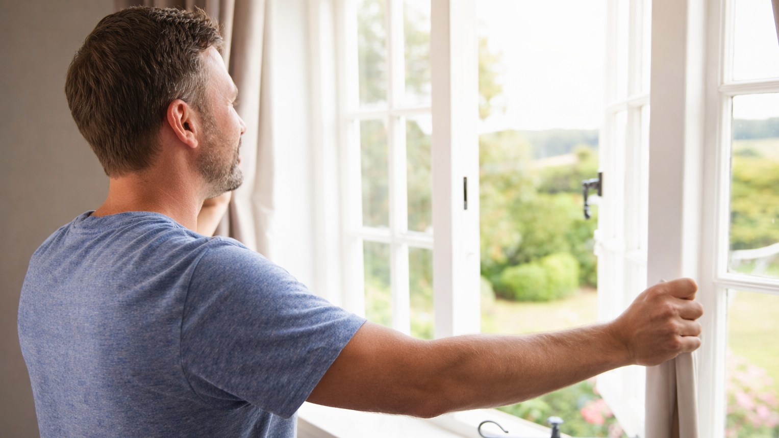 man opening window