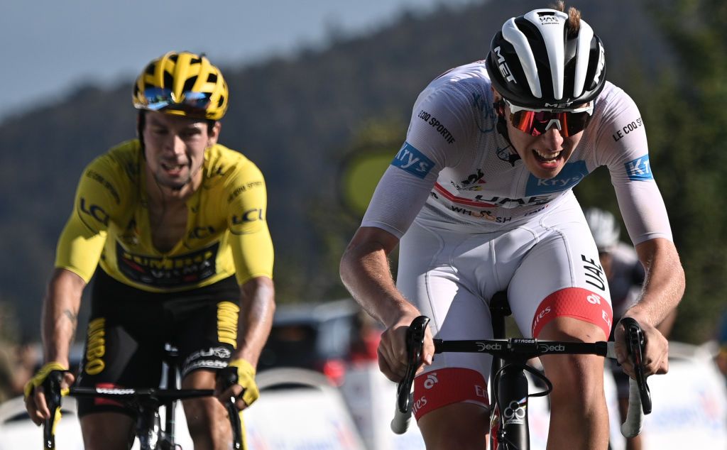 Stage winner Team UAE Emirates rider Slovenias Tadej Pogacar R wearing the best youngs white jersey celebrates as he crosses the finish line ahead of Team Jumbo rider Slovenias Primoz Roglic wearing the overall leaders yellow jersey at the Grand Colombier pass during the 15th stage of the 107th edition of the Tour de France cycling race 175 km between Lyon and Grand Colombier on September 13 2020 Photo by AnneChristine POUJOULAT AFP Photo by ANNECHRISTINE POUJOULATAFP via Getty Images
