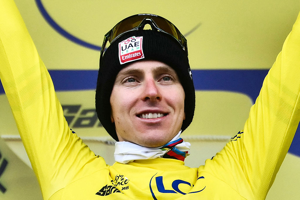 UAE Team Emirates - XRG team&#039;s Slovenian rider Tadej Pogacar celebrates on the podium with the overall leader&#039;s yellow jersey after the 14th stage of the 112th edition of the Tour de France cycling race, 182.6 km between Pau and Luchon-Superbagneres, in the Pyrenees mountains of southwestern France, on July 19, 2025. (Photo by Marco BERTORELLO / AFP)