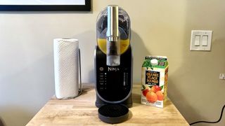 Making an orange juice slushie with Ninja Slushi machine