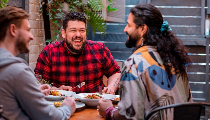 Group of happy friends eating restaurant