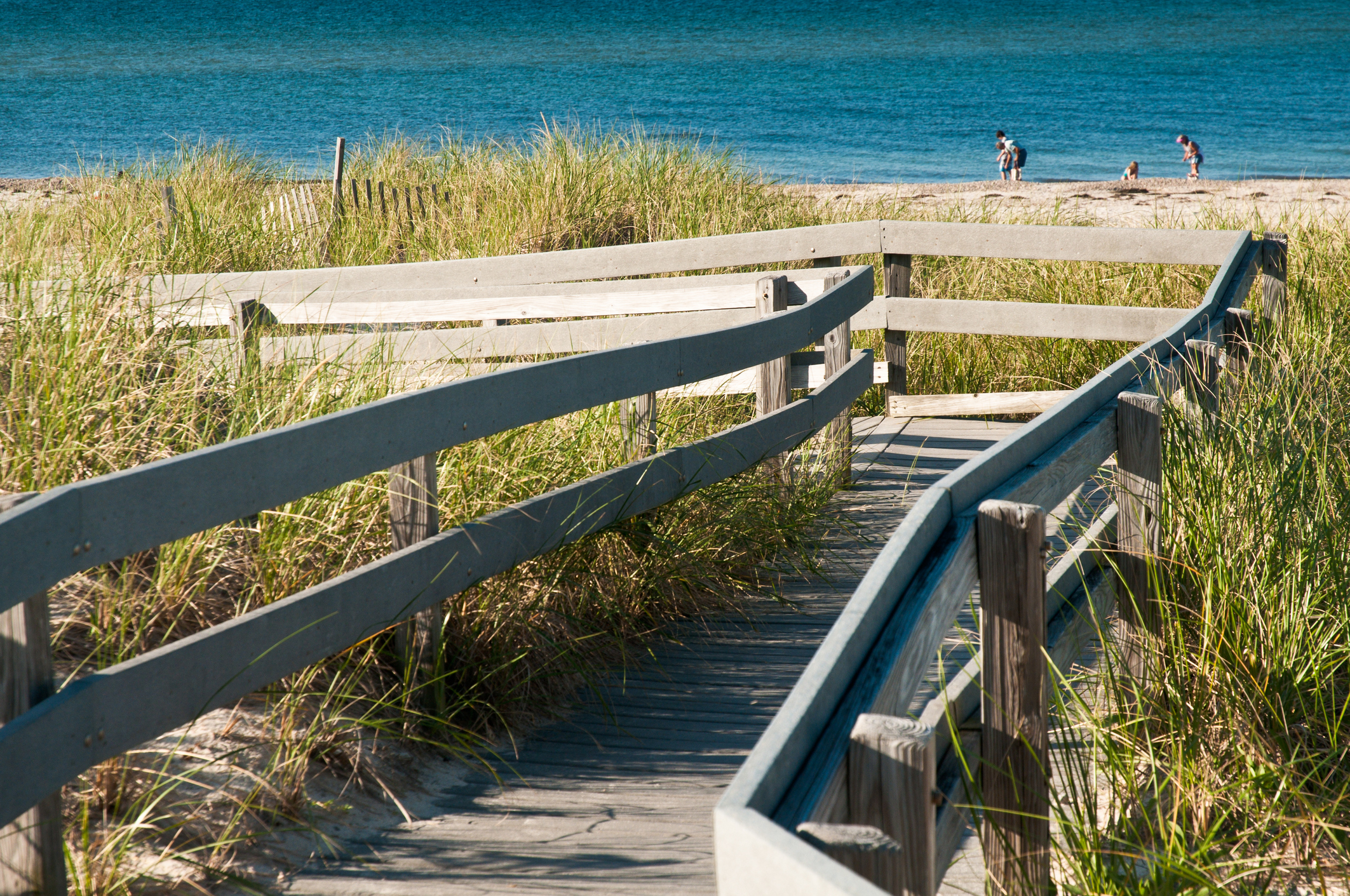A wooden walkway leads over the dunes at Sandy Neck Beach in Sandwich, Massachusetts