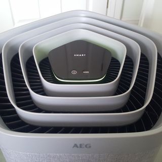 The AEG AX91-604GY Connected Air Purifier showing the word 'Smart' on its LED display