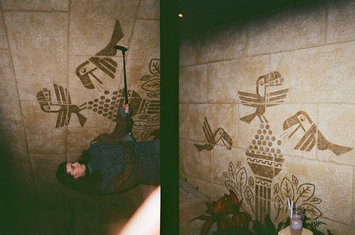 Two photos of a woman and a mural taken on a Kodak Ektar H35 Half Frame film camera