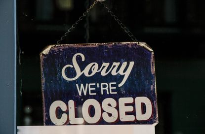 Sorry we&#039;re closed sign hanging in window