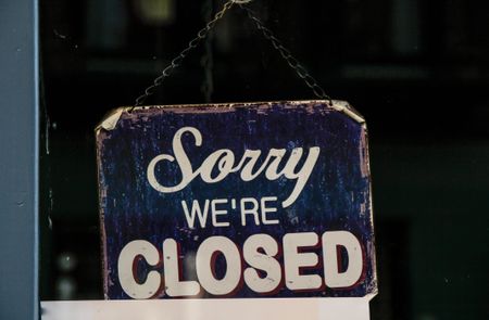 Sorry we're closed sign hanging in window