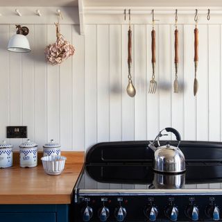 kitchen with wall panelling and range cooker and reclaimed wall light future