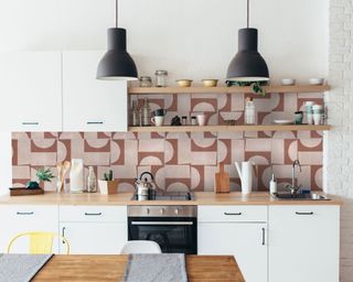 a white kitchen with LIVDEN Puzzle Piece Clay tiles on a kitchen backsplash
