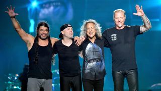Metallica smiling together on stage