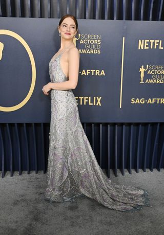 Emma Stone arrives at the 2024 SAG Awards in a silver dress