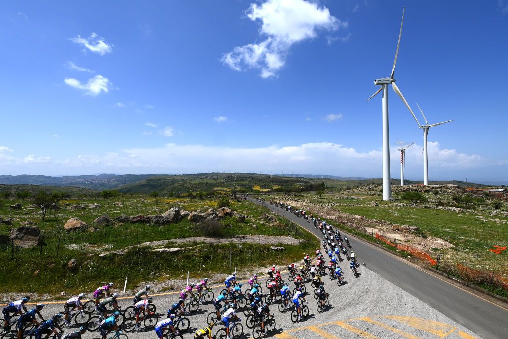 ETNA PIAZZALE RIFUGIO SAPIENZA ITALY MAY 10 A general view of the peloton passing through a windmill park at Vizzini 634m during the 105th Giro dItalia 2022 Stage 4 a 172km stage from Avola to Etna Piazzale Rifugio Sapienza 1899m Giro WorldTour on May 10 2022 in Etna Piazzale Rifugio Sapienza Italy Photo by Tim de WaeleGetty Images