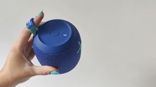 Ultimate Ears Wonderboom 2 review: holding a speaker and showing the top